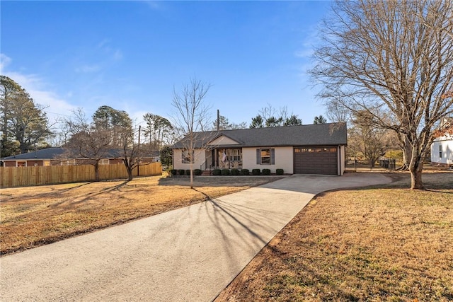 ranch-style house featuring a garage and a front yard