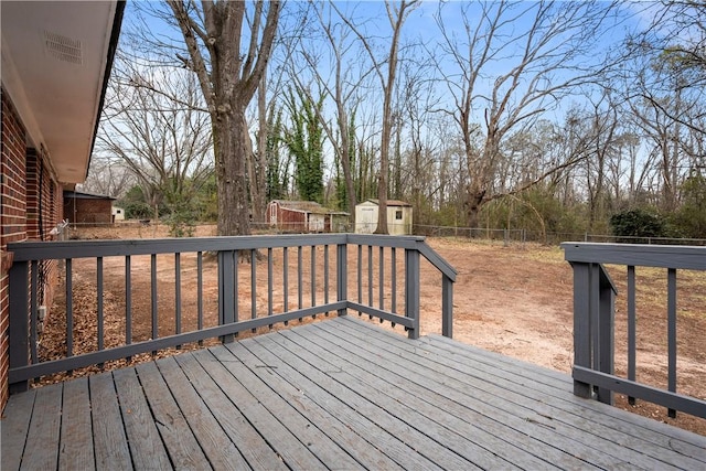 wooden deck featuring a storage unit