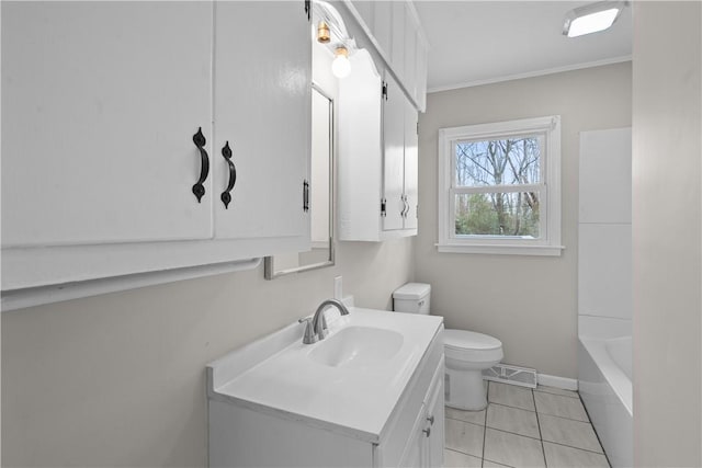 bathroom with vanity, ornamental molding, tile patterned floors, and toilet