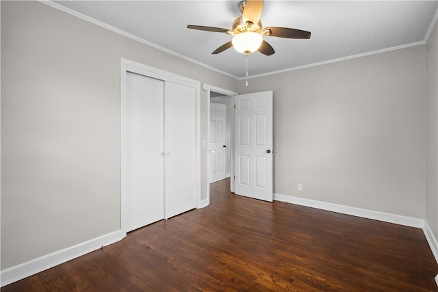 unfurnished bedroom with dark hardwood / wood-style flooring, crown molding, a closet, and ceiling fan