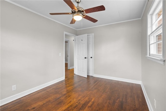 empty room with crown molding, dark hardwood / wood-style floors, and ceiling fan