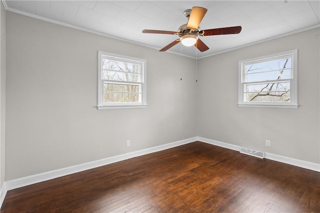 spare room featuring dark hardwood / wood-style flooring, plenty of natural light, ornamental molding, and ceiling fan