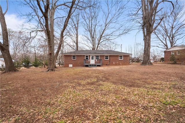 rear view of property featuring a wooden deck