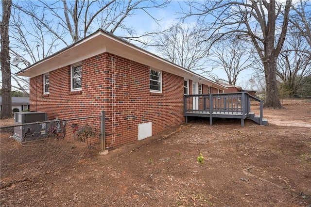 view of home's exterior featuring a wooden deck and central air condition unit