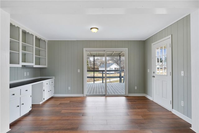 kitchen featuring built in desk, dark hardwood / wood-style floors, white cabinets, and plenty of natural light