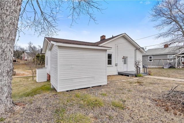 back of property featuring a lawn