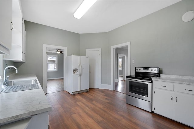 kitchen with electric stove, sink, white refrigerator with ice dispenser, white cabinets, and dark hardwood / wood-style flooring