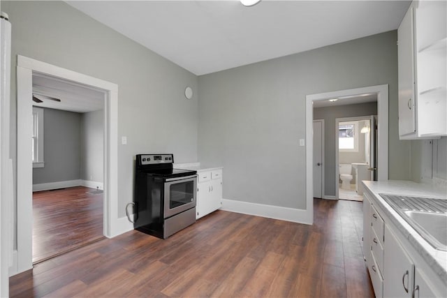 kitchen featuring white cabinetry, sink, electric range, and dark hardwood / wood-style floors