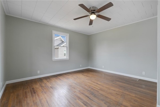 unfurnished room featuring dark wood-type flooring, ceiling fan, and crown molding