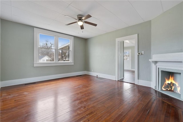 unfurnished living room featuring hardwood / wood-style floors and ceiling fan