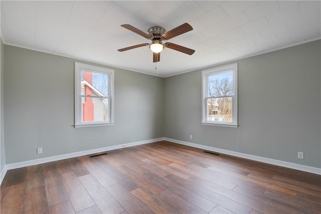 unfurnished room with crown molding, dark wood-type flooring, and ceiling fan