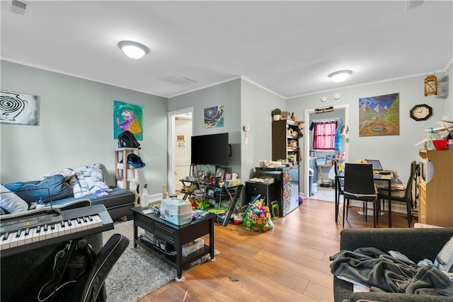 living room with crown molding and light wood-type flooring