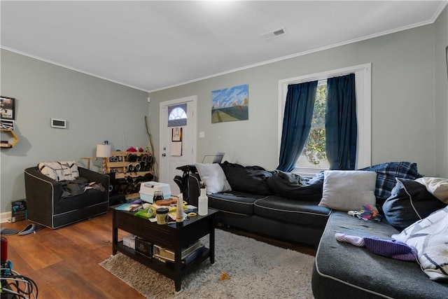 living room featuring crown molding and wood-type flooring