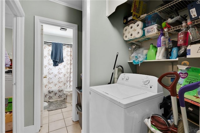 clothes washing area featuring washer / dryer and light tile patterned floors