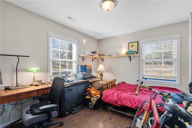 bedroom with dark wood-type flooring