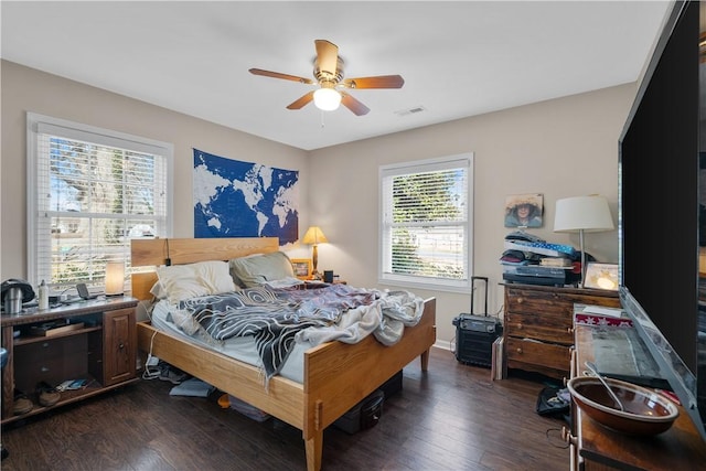 bedroom with dark hardwood / wood-style floors and ceiling fan