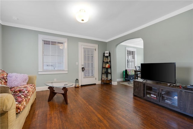 living room with dark hardwood / wood-style flooring and crown molding