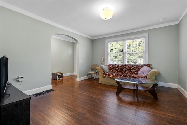 living room with crown molding and dark wood-type flooring