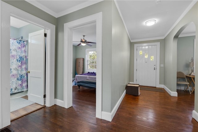 foyer entrance with crown molding and dark hardwood / wood-style floors