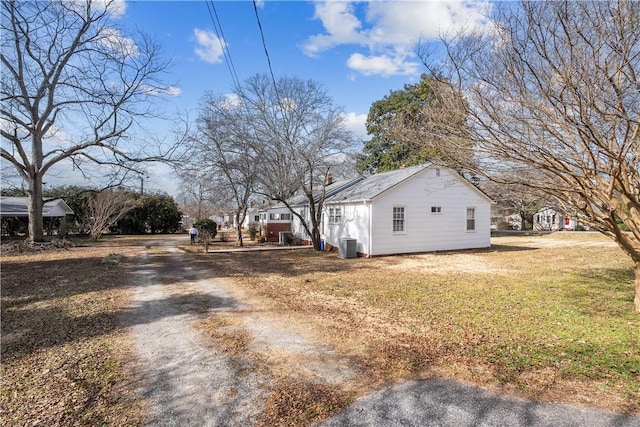 exterior space featuring cooling unit and a yard