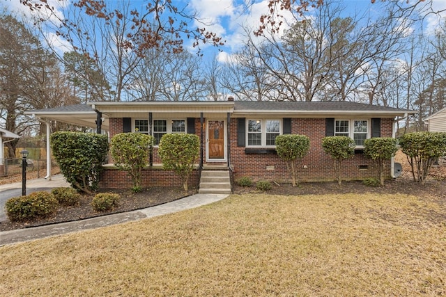 ranch-style house featuring a carport and a front yard