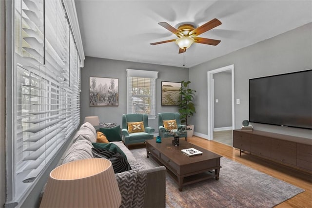 living room with wood-type flooring and ceiling fan