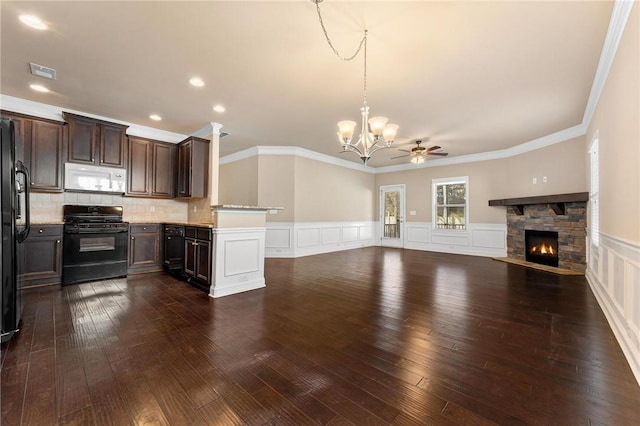 kitchen with dark hardwood / wood-style floors, a fireplace, hanging light fixtures, dark brown cabinetry, and black appliances