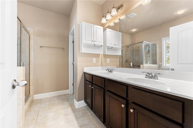 bathroom featuring vanity, a shower with shower door, and tile patterned floors