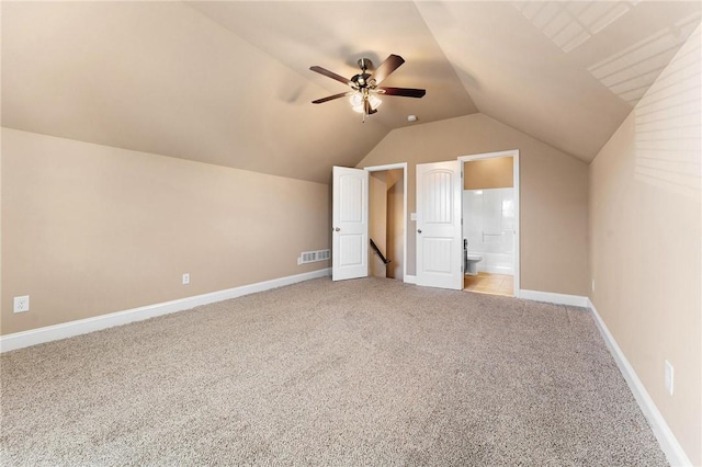 bonus room with lofted ceiling, carpet flooring, and ceiling fan