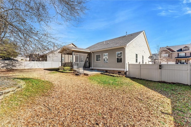 back of property featuring a patio, a sunroom, and a lawn