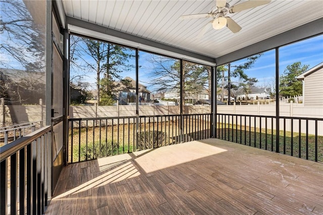 unfurnished sunroom featuring ceiling fan