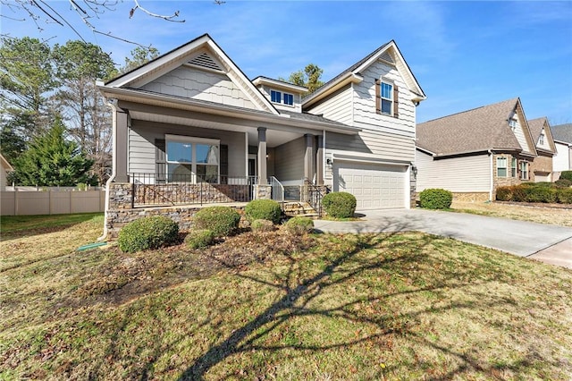 craftsman house with a garage, covered porch, and a front lawn