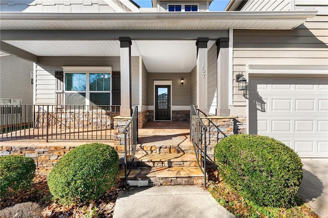 property entrance featuring a garage and covered porch