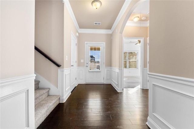 entrance foyer featuring dark hardwood / wood-style flooring and crown molding