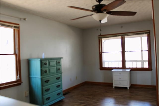 unfurnished bedroom with dark wood-type flooring and multiple windows