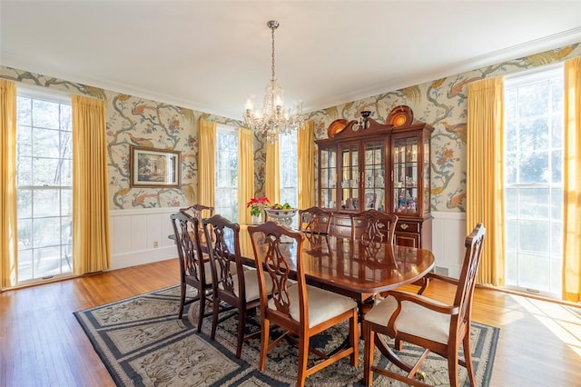 dining room featuring ornamental molding, a chandelier, and light wood-type flooring