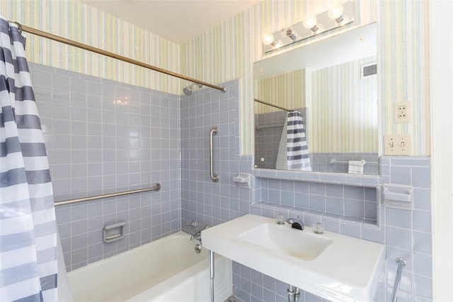 bathroom featuring tile walls and shower / bath combination with curtain