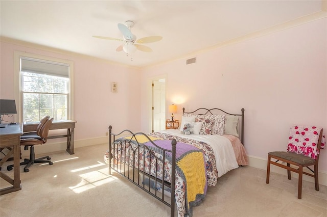 carpeted bedroom with ornamental molding and ceiling fan