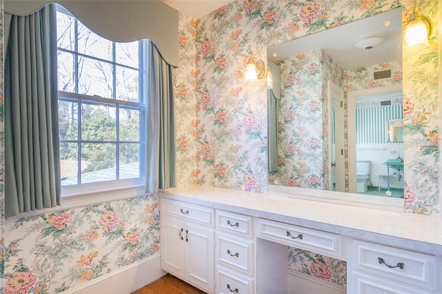 bathroom featuring vanity and toilet