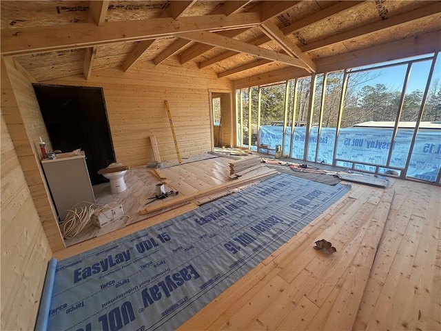 interior space with plenty of natural light and vaulted ceiling with beams