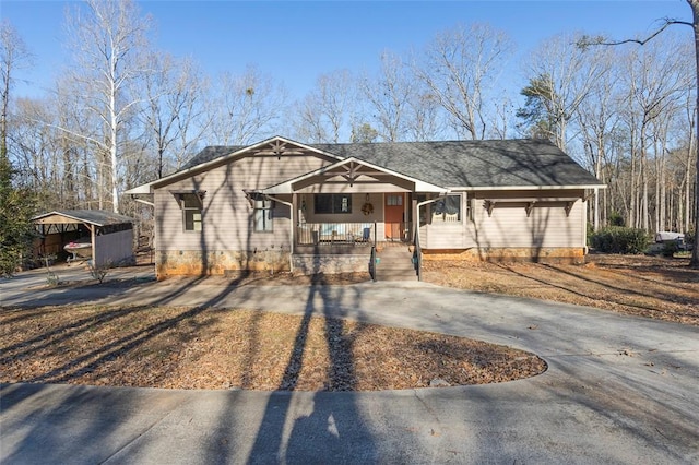 view of front of property featuring a carport and covered porch