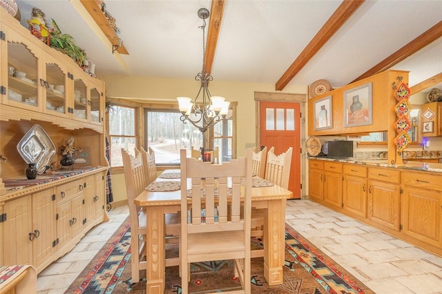 dining space with plenty of natural light, a chandelier, and vaulted ceiling with beams