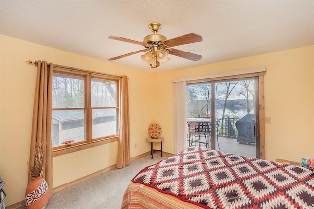 carpeted bedroom featuring ceiling fan and access to exterior