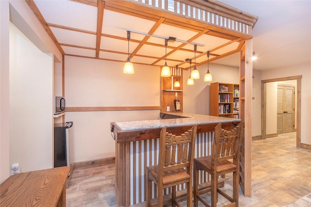 bar with decorative light fixtures and wood-type flooring