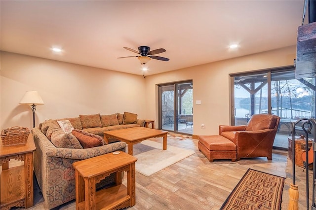 living room featuring ceiling fan and light wood-type flooring