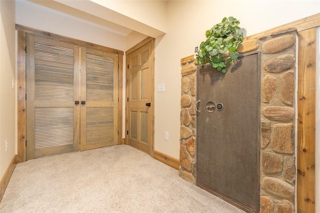 hall with light colored carpet