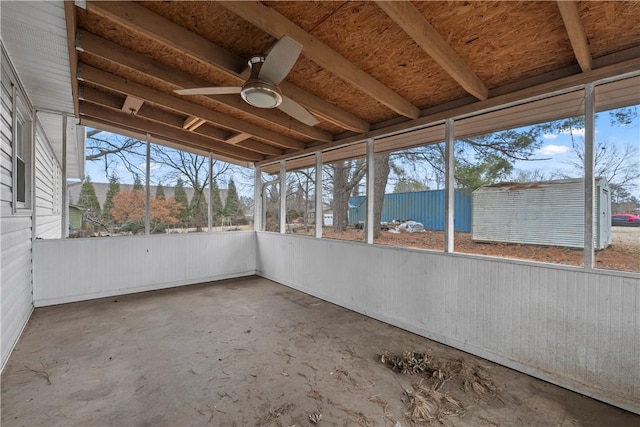 unfurnished sunroom featuring ceiling fan