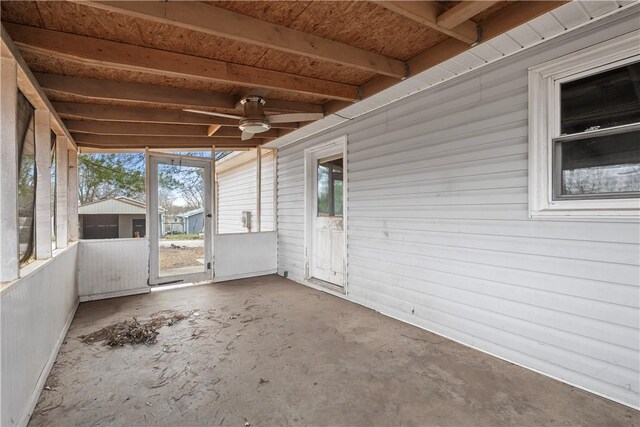 unfurnished sunroom with ceiling fan