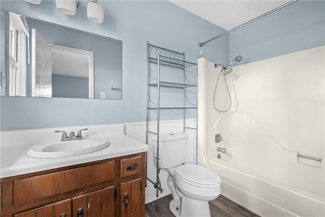 full bathroom featuring toilet, vanity, bathtub / shower combination, and hardwood / wood-style flooring