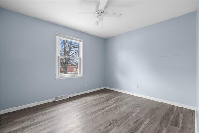 spare room featuring hardwood / wood-style flooring and ceiling fan